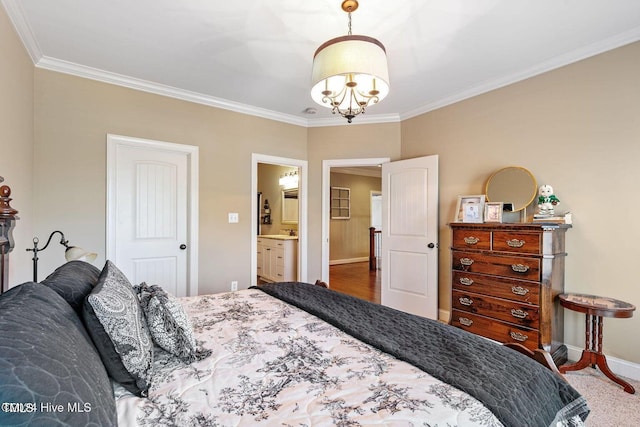 bedroom with a chandelier, connected bathroom, and crown molding