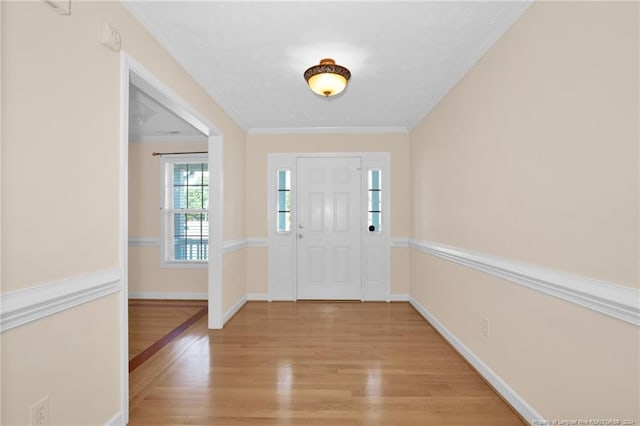 entryway featuring crown molding and light hardwood / wood-style floors