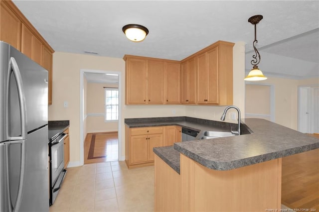 kitchen with pendant lighting, sink, kitchen peninsula, and stainless steel appliances