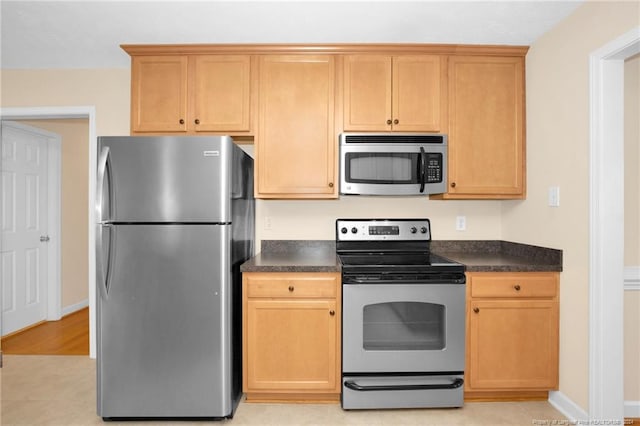 kitchen featuring light tile patterned floors and stainless steel appliances