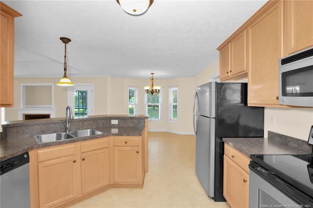 kitchen featuring sink, hanging light fixtures, light brown cabinetry, a notable chandelier, and stainless steel appliances