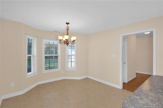 empty room with an inviting chandelier