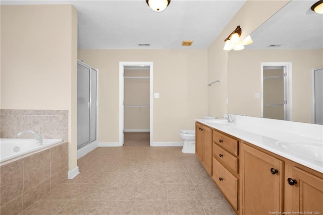 full bathroom featuring separate shower and tub, tile patterned floors, vanity, and toilet