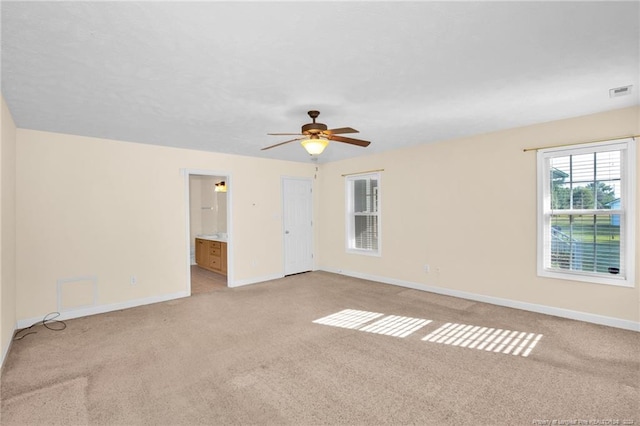 carpeted spare room with ceiling fan