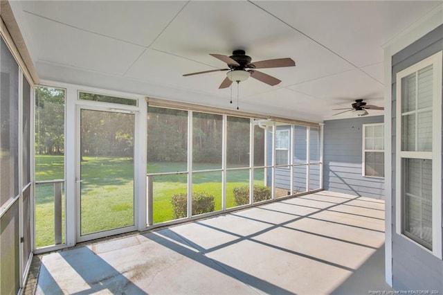 unfurnished sunroom with ceiling fan