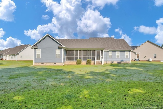 back of property with a lawn and a sunroom