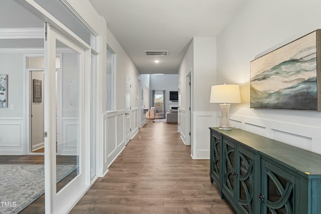 corridor featuring dark hardwood / wood-style floors and crown molding