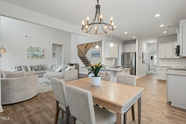 dining room featuring a chandelier and light hardwood / wood-style flooring