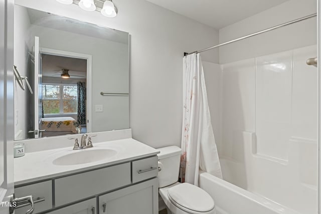 full bathroom with ceiling fan, shower / tub combo with curtain, vanity, and toilet