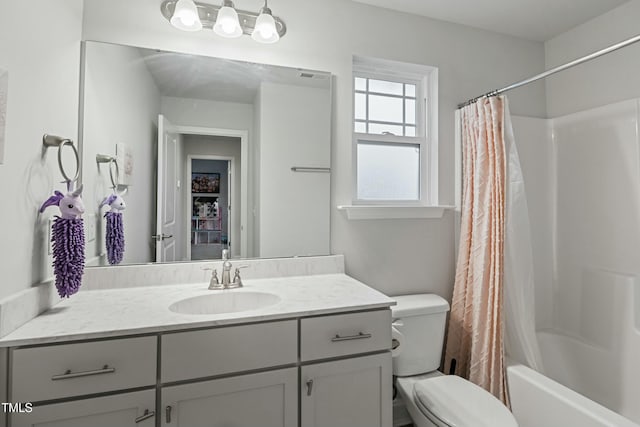 full bathroom featuring vanity, toilet, and shower / tub combo