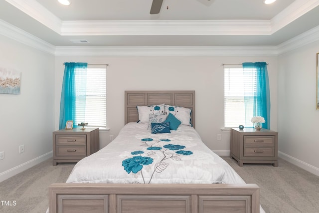 carpeted bedroom with a raised ceiling, ceiling fan, and crown molding