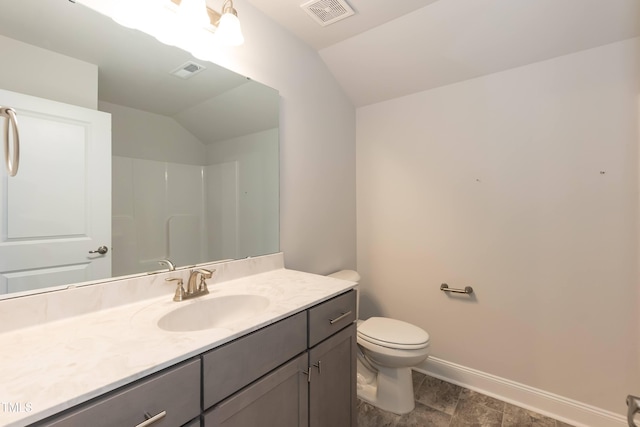 bathroom with toilet, a shower, lofted ceiling, and vanity