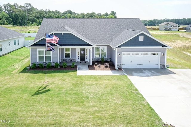 craftsman-style house featuring a front yard, a porch, and a garage