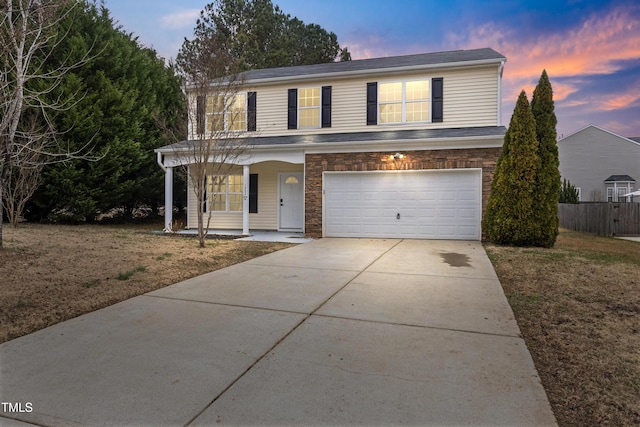 view of front property with covered porch and a garage