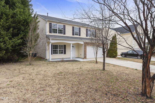 view of front of house with covered porch, a garage, and a front lawn