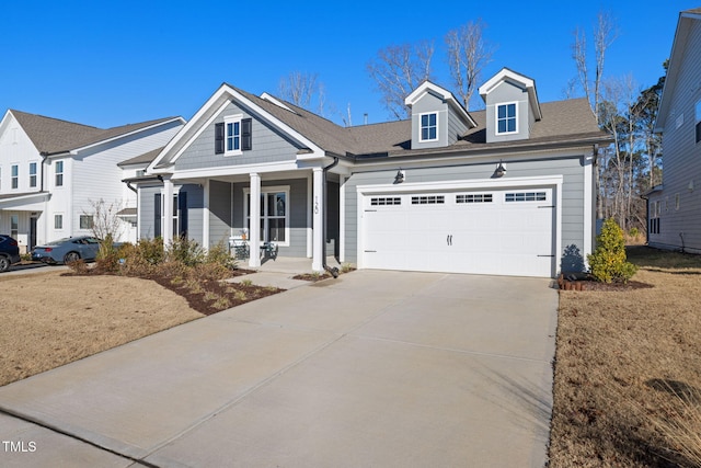 view of front facade featuring covered porch and a garage