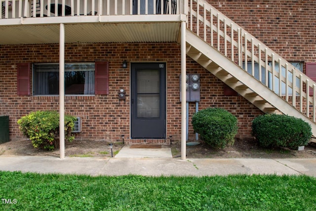 view of exterior entry featuring a balcony