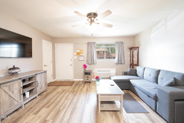 living room featuring ceiling fan and light hardwood / wood-style flooring