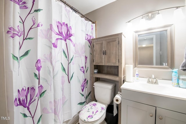 bathroom with vanity, toilet, and walk in shower