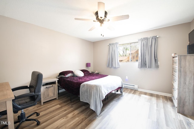 bedroom featuring ceiling fan, a baseboard radiator, and wood-type flooring