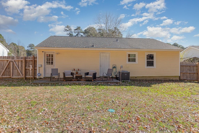 rear view of property featuring central AC unit, a patio area, and a yard