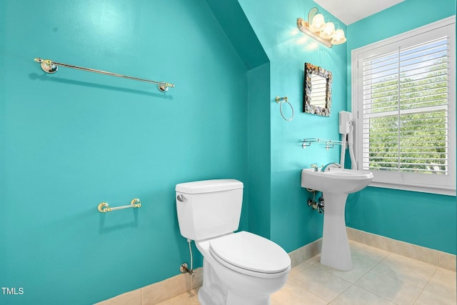 bathroom with tile patterned flooring, toilet, and vaulted ceiling