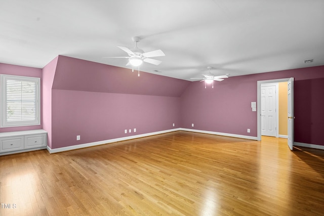 bonus room with light hardwood / wood-style floors, ceiling fan, and lofted ceiling