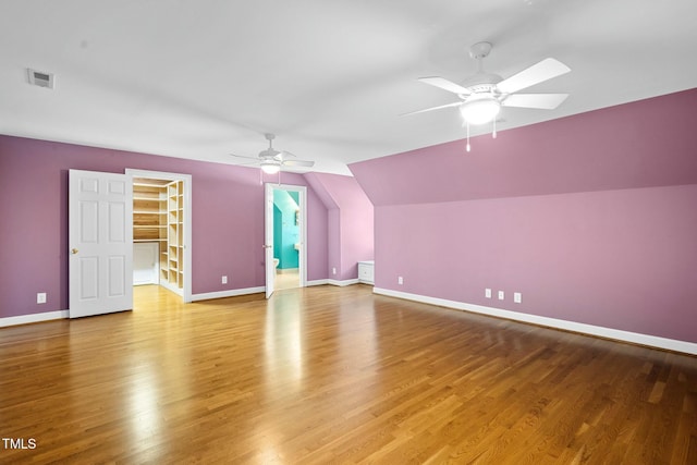 additional living space with ceiling fan, wood-type flooring, and lofted ceiling