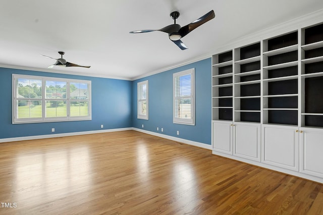 spare room with hardwood / wood-style floors, ceiling fan, and crown molding