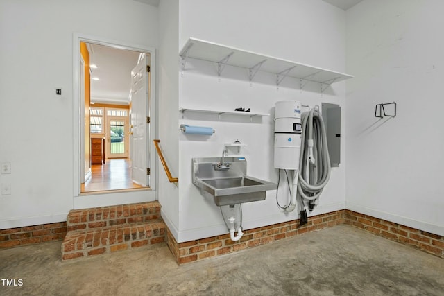 misc room with concrete flooring and sink