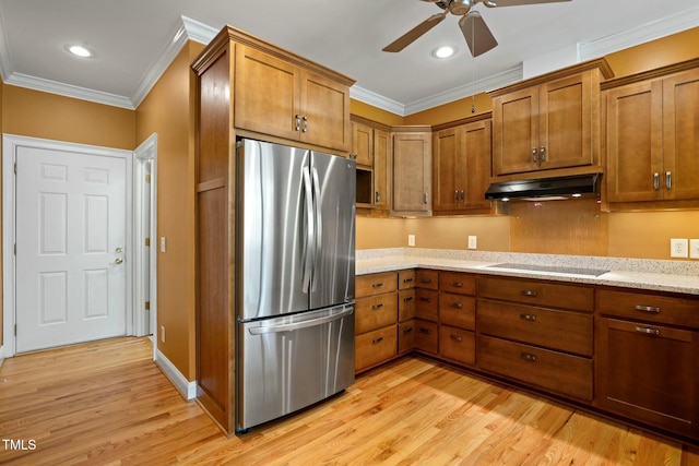 kitchen with stainless steel refrigerator, light stone counters, light hardwood / wood-style floors, electric cooktop, and ornamental molding