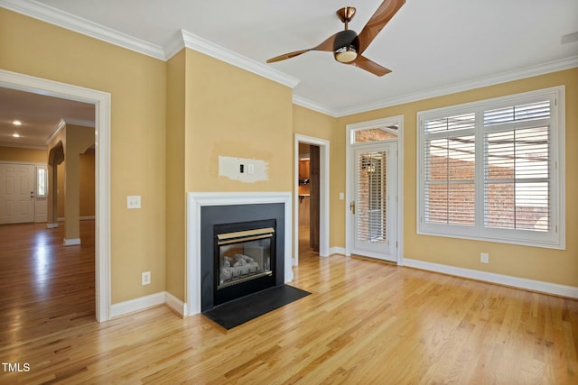 unfurnished living room featuring ceiling fan, light hardwood / wood-style floors, and ornamental molding