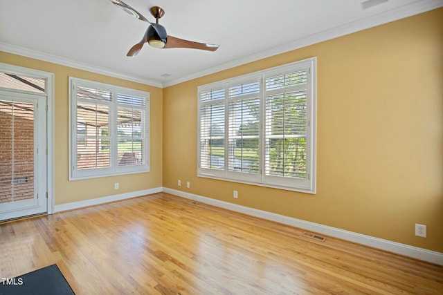 spare room with crown molding, ceiling fan, and light wood-type flooring