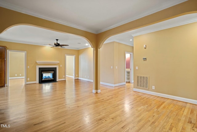 unfurnished living room featuring crown molding, ceiling fan, and light wood-type flooring