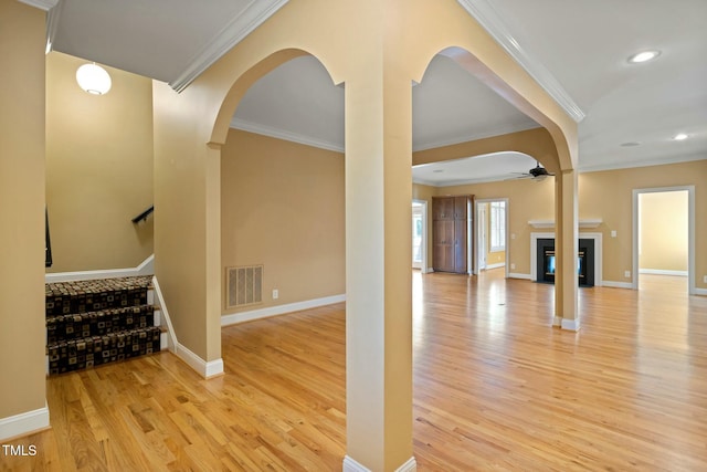 entrance foyer featuring ceiling fan, light hardwood / wood-style floors, and crown molding