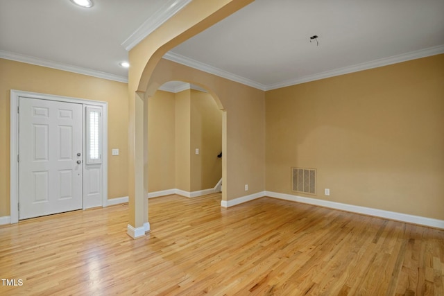 foyer with light hardwood / wood-style flooring and crown molding