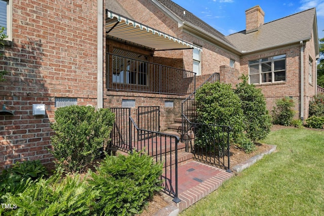 rear view of property featuring a lawn