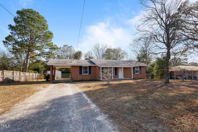 ranch-style home featuring a carport