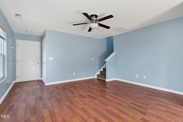 unfurnished living room with a textured ceiling, dark hardwood / wood-style floors, and ceiling fan