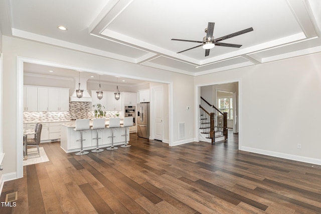 unfurnished living room with dark hardwood / wood-style flooring and ceiling fan