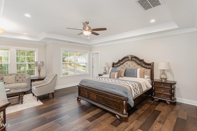 bedroom featuring ceiling fan, dark hardwood / wood-style floors, and a raised ceiling