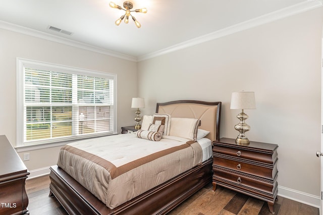 bedroom featuring hardwood / wood-style flooring, ornamental molding, and a notable chandelier