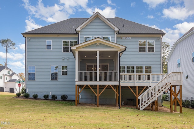 back of house with a lawn, a wooden deck, and a sunroom