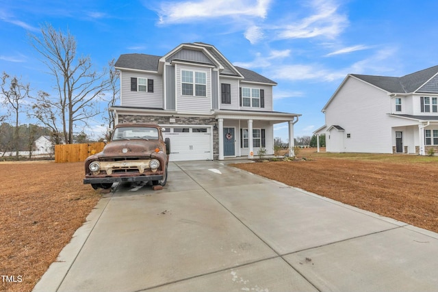 view of front of property featuring a porch, a garage, and a front lawn