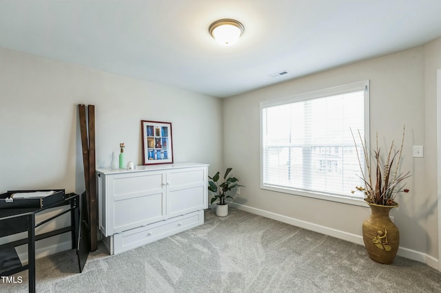 bedroom with light carpet, visible vents, and baseboards