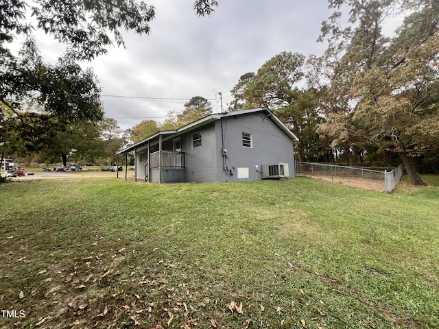 view of property exterior featuring a lawn and cooling unit