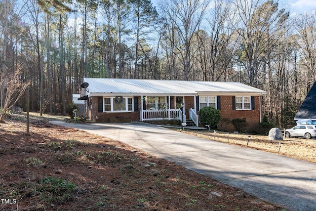 single story home featuring covered porch