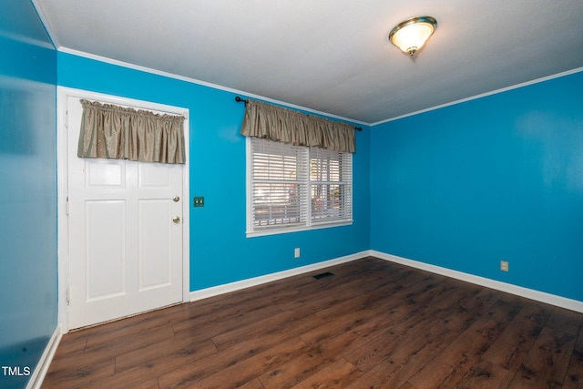 unfurnished room with crown molding and dark hardwood / wood-style floors