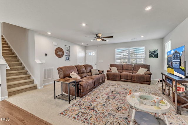 living room featuring ceiling fan and light colored carpet