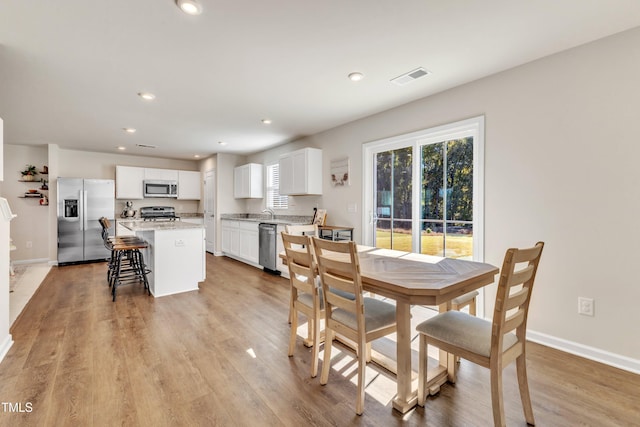 dining space featuring light wood-type flooring